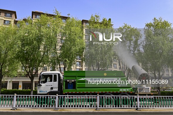 A fog cannon truck is carrying out spraying operations on Jiangjunshan Road in Qingzhou, China, on April 17, 2024. Every April and May is th...