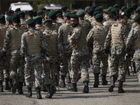 Members of the Iranian Army's land force are walking along an area after marching in a military parade to mark Iran's Army Day anniversary a...