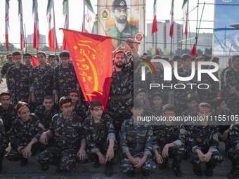 Members of the Basij paramilitary force are posing for a photograph as they prepare to march in a military parade marking Iran's Army Day an...