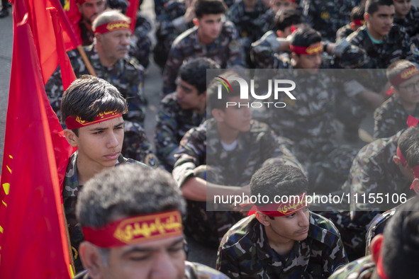 Members of the Basij paramilitary force are preparing to march in a military parade marking the anniversary of Iran's Army Day at an Army mi...