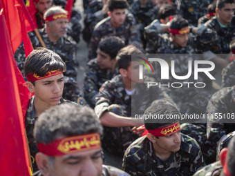 Members of the Basij paramilitary force are preparing to march in a military parade marking the anniversary of Iran's Army Day at an Army mi...