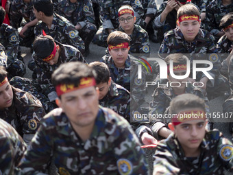 Iranian schoolboys, who are also members of the Basij paramilitary force, are preparing to march in a military parade marking Iran's Army Da...