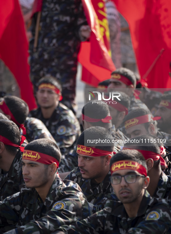 Members of the Basij paramilitary force are preparing to march in a military parade marking the anniversary of Iran's Army Day at an Army mi...