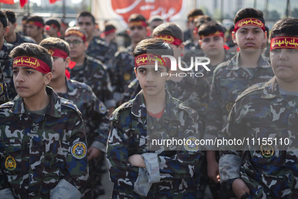 Iranian schoolboys, who are also members of the Basij paramilitary force, are preparing to march in a military parade marking Iran's Army Da...