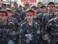 Iranian schoolboys, who are also members of the Basij paramilitary force, are preparing to march in a military parade marking Iran's Army Da...