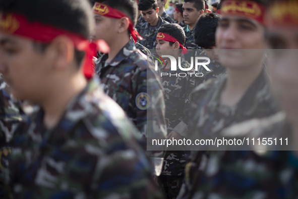 Iranian schoolboys, who are also members of the Basij paramilitary force, are preparing to march in a military parade marking Iran's Army Da...