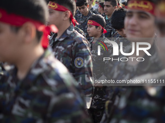 Iranian schoolboys, who are also members of the Basij paramilitary force, are preparing to march in a military parade marking Iran's Army Da...