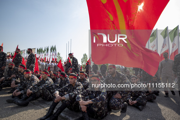 Members of the Basij paramilitary force are preparing to march in a military parade marking the anniversary of Iran's Army Day at an Army mi...