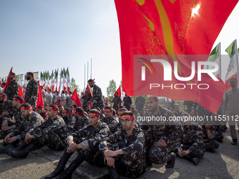 Members of the Basij paramilitary force are preparing to march in a military parade marking the anniversary of Iran's Army Day at an Army mi...