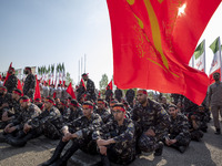 Members of the Basij paramilitary force are preparing to march in a military parade marking the anniversary of Iran's Army Day at an Army mi...