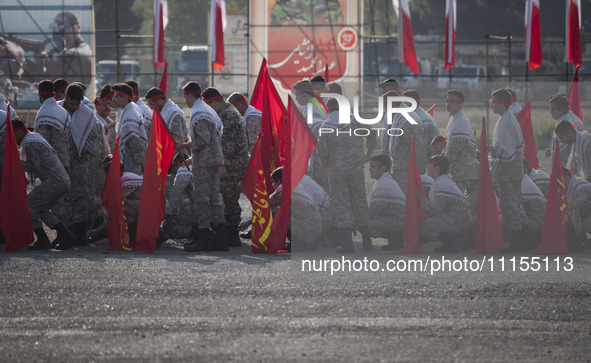 Members of the Basij paramilitary force are preparing to march in a military parade marking the anniversary of Iran's Army Day at an Army mi...