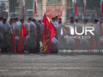 Members of the Basij paramilitary force are preparing to march in a military parade marking the anniversary of Iran's Army Day at an Army mi...