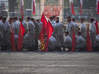 Members of the Basij paramilitary force are preparing to march in a military parade marking the anniversary of Iran's Army Day at an Army mi...