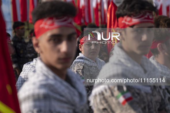 Iranian schoolboys, who are also members of the Basij paramilitary force, are preparing to march in a military parade marking Iran's Army Da...