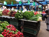 A woman shops for spring vegetables and herbs on Old Kleparz Market in Old Town of Krakow as spring gardening season started in Poland on Ap...