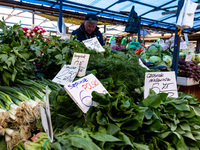 A man sells early vegetables are on a market stand on Old Kleparz Market in Old Town of Krakow as spring gardening season started in Poland...