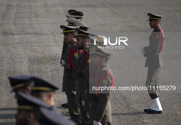 Members of the Iranian Army's honor guard are standing at attention during a military parade marking the anniversary of Iran's Army Day at a...