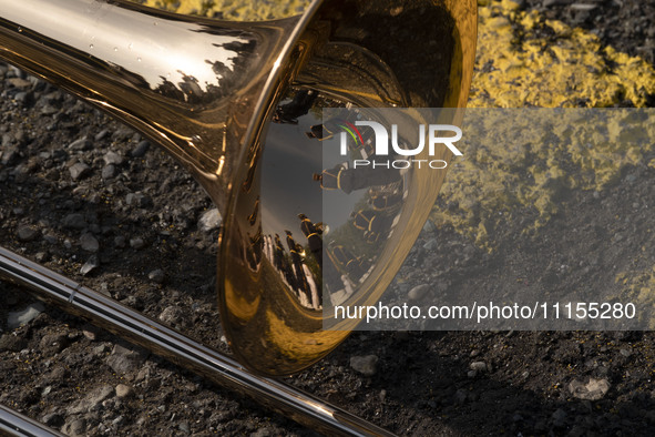 Members of an Iranian Army's music band are reflected on a musical instrument before a military parade marking Iran's Army Day anniversary a...