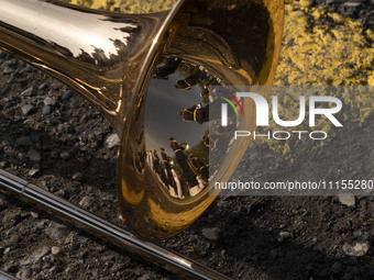 Members of an Iranian Army's music band are reflected on a musical instrument before a military parade marking Iran's Army Day anniversary a...