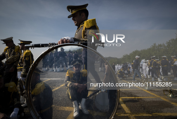 Members of an Iranian Army's music band are waiting to perform in a military parade marking Iran's Army Day anniversary at an Army military...