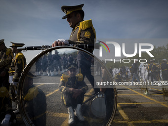 Members of an Iranian Army's music band are waiting to perform in a military parade marking Iran's Army Day anniversary at an Army military...