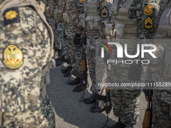 Members of the Iranian Army's land force are standing at attention during a military parade marking the anniversary of Iran's Army Day at an...