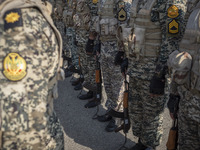 Members of the Iranian Army's land force are standing at attention during a military parade marking the anniversary of Iran's Army Day at an...