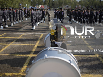 A member of the Iranian Army's music band is waiting to perform in a military parade marking Iran's Army Day anniversary at an Army military...