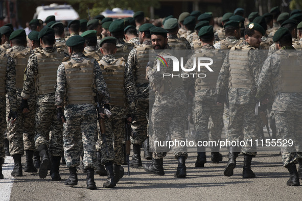 Members of the Iranian Army's land force are walking along an area after participating in a military parade to mark Iran's Army Day annivers...