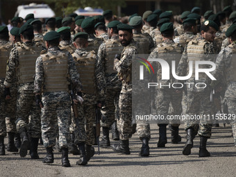 Members of the Iranian Army's land force are walking along an area after participating in a military parade to mark Iran's Army Day annivers...