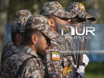 Members of the Iranian Army's land force are preparing to march in a military parade marking Iran's Army Day anniversary at an Army military...