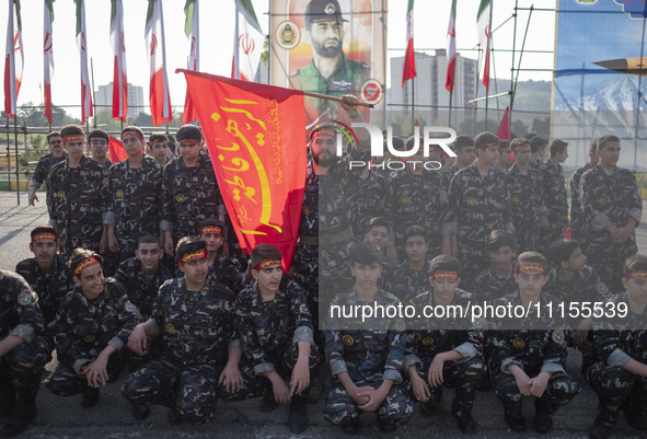 Members of the Basij paramilitary force are posing for a photograph as they prepare to march in a military parade marking Iran's Army Day an...