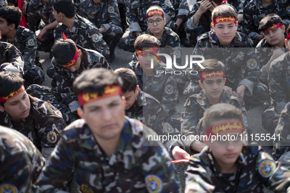 Iranian schoolboys, who are also members of the Basij paramilitary force, are preparing to march in a military parade marking Iran's Army Da...