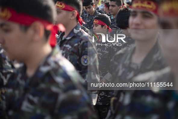 Iranian schoolboys, who are also members of the Basij paramilitary force, are preparing to march in a military parade marking Iran's Army Da...