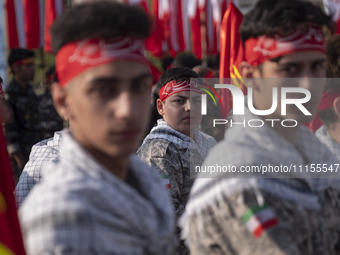 Iranian schoolboys, who are also members of the Basij paramilitary force, are preparing to march in a military parade marking Iran's Army Da...