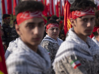 Iranian schoolboys, who are also members of the Basij paramilitary force, are preparing to march in a military parade marking Iran's Army Da...