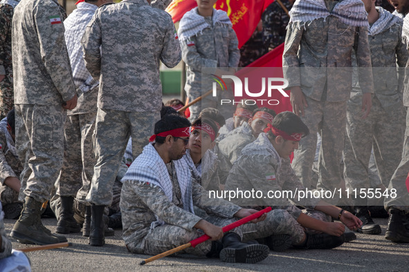 Members of the Basij paramilitary force are preparing to march in a military parade marking Iran's Army Day anniversary at an Army military...