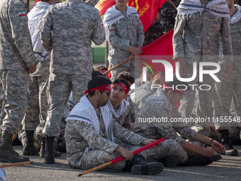 Members of the Basij paramilitary force are preparing to march in a military parade marking Iran's Army Day anniversary at an Army military...