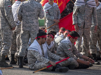 Members of the Basij paramilitary force are preparing to march in a military parade marking Iran's Army Day anniversary at an Army military...