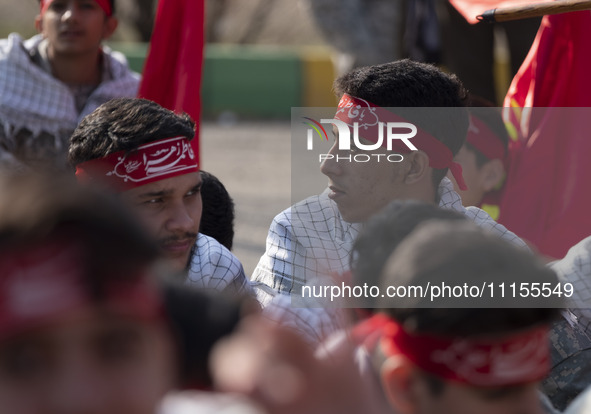 Members of the Basij paramilitary force are preparing to march in a military parade marking Iran's Army Day anniversary at an Army military...