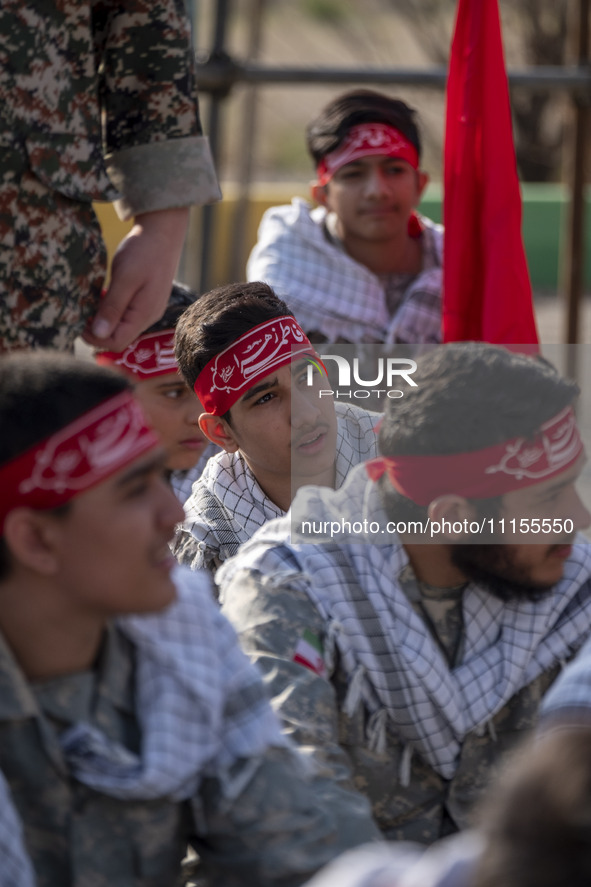 Members of the Basij paramilitary force are preparing to march in a military parade marking Iran's Army Day anniversary at an Army military...