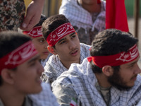 Members of the Basij paramilitary force are preparing to march in a military parade marking Iran's Army Day anniversary at an Army military...