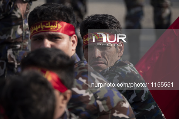 Members of the Basij paramilitary force are preparing to march in a military parade marking Iran's Army Day anniversary at an Army military...