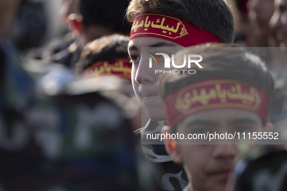 Iranian schoolboys, who are also members of the Basij paramilitary force, are preparing to march in a military parade marking Iran's Army Da...