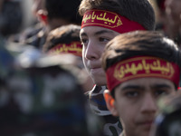 Iranian schoolboys, who are also members of the Basij paramilitary force, are preparing to march in a military parade marking Iran's Army Da...