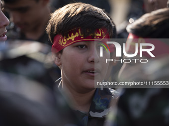 An Iranian schoolboy, who is also a member of the Basij paramilitary force, is preparing to march in a military parade marking Iran's Army D...