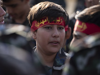 An Iranian schoolboy, who is also a member of the Basij paramilitary force, is preparing to march in a military parade marking Iran's Army D...