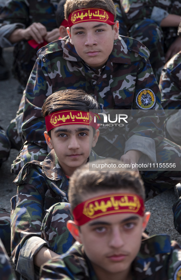 Iranian schoolboys, who are also members of the Basij paramilitary force, are preparing to march in a military parade marking Iran's Army Da...