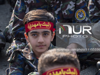 Iranian schoolboys, who are also members of the Basij paramilitary force, are preparing to march in a military parade marking Iran's Army Da...