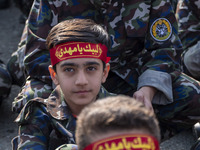 Iranian schoolboys, who are also members of the Basij paramilitary force, are preparing to march in a military parade marking Iran's Army Da...